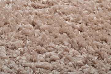 Texture of modern beige shaggy carpet - background
