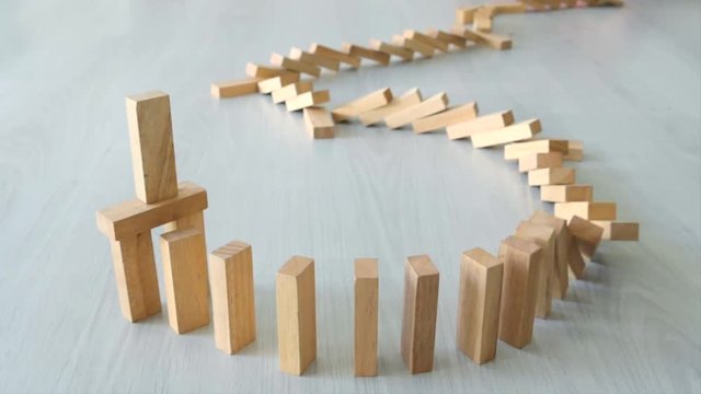 Playing wooden blocks domino on the floor.