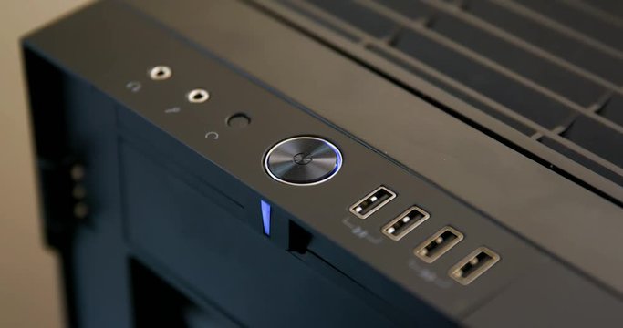 Man Presses Power Button to Turn on Desktop Computer