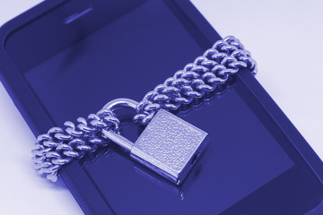 Small lock and chain on a smartphone. Mobile phone security and data protection concept. Toned photo