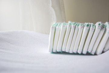 Group of disposable diapers arranged over a white changing table