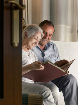grandparents looking at album photos