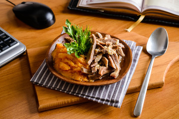 mashed chickpea peas and beef tongue on a dark background with reflection studio