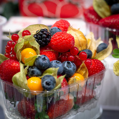 Showcase with set ready to go with different types of delicious berries. Raspberry, strawberry,...