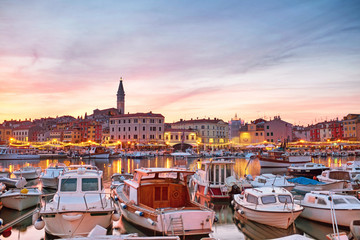 Picturesque evening in Rovinj port with lots of boats in the front in Croatia.
