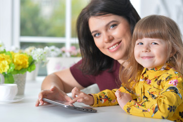 Mother and daughter playing game on laptop