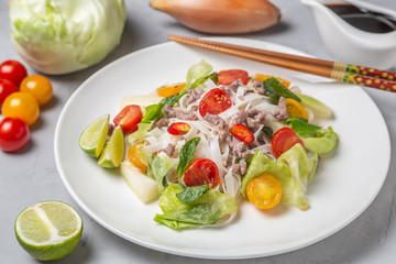 Spicy Thai salad with ground beef and rice noodles