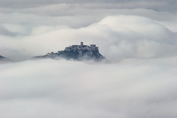 Fototapeta na wymiar Unique Spis (Spiš, Spišský) castle in the mist. Second biggest castle in Middle Europe, Unesco Wold Heritage, Slovakia