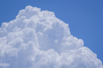 Cumulus cloud with development in sky during afternoon.