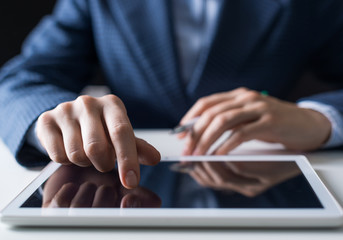 Male hand touching screen of digital tablet