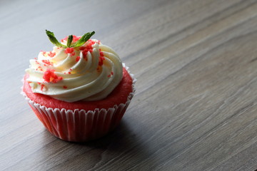 Red velvet cupcake. The finished cakes are on the table. Decorated with mint leaves.