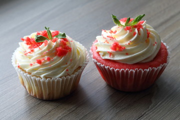 Red velvet cupcake. The finished cakes are on the table. Decorated with mint leaves.