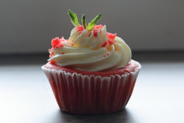 Red velvet cupcake. The finished cakes are on the table. Decorated with mint leaves.