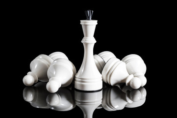 White chess on black reflective background.