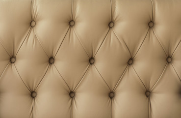 Naklejka premium texture of sofa upholstery, armchairs. Leather sofa, leather chair. retro furniture surface. .yellow, red, beige
