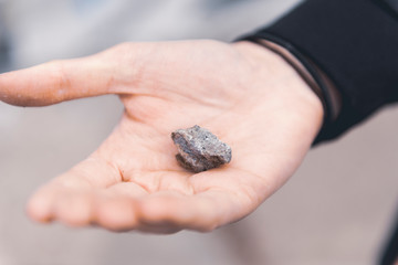 Close up hand holding stone