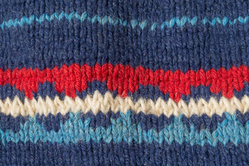 Knitted texture with blue pattern close up