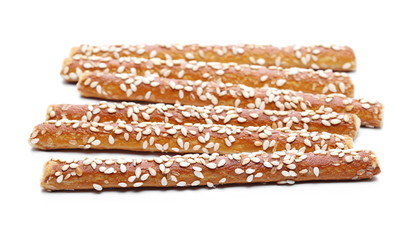 Cracker pretzel bread sticks with sesame isolated on white background