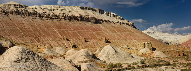 Panorama of white gypsum and red sedimentary layers at Aktau Mountain Altyn Emel National Park...