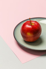 Fresh picked red apple in a plate