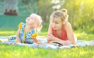 Happy mother with child enjoying together nature