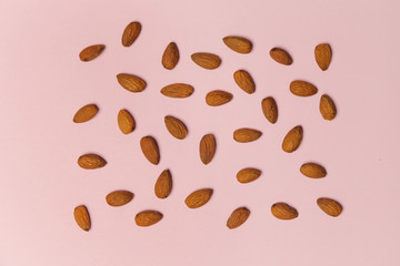 Almonds on pink background