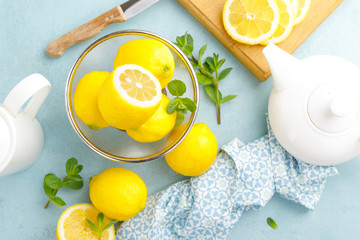 Sliced and whole lemons with mint