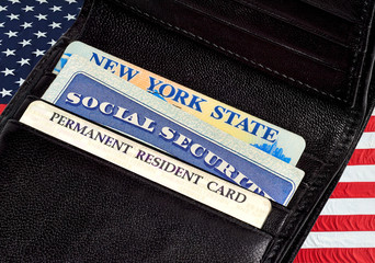 Driver License,  Permanent resident or green card and Social Security Cards in wallet on American...