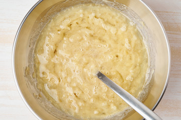 Mashed banana with egg and oil. Step by step recipe. Homemade Banana bread. Top view, white table.