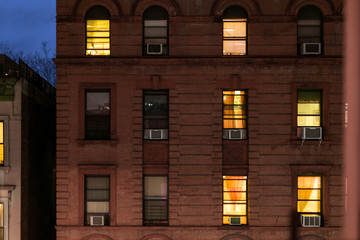 Facade of a typical brownstone apartment building at night, Harlem, New York City, NY, USA