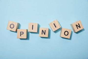 top view of wooden cubes with letters on blue surface