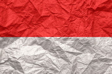 Monaco flag on old crumpled craft paper.