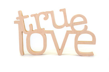 wooden word with the words "true love" on a white background