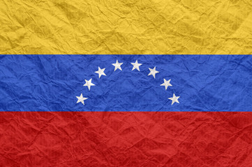 Fototapeta premium Venezuela flag on old crumpled craft paper.
