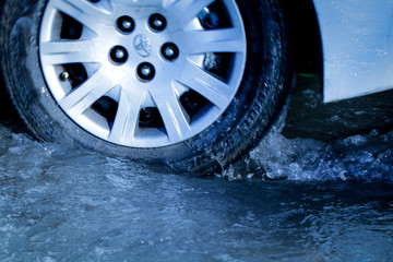 close up car tire in puddle 