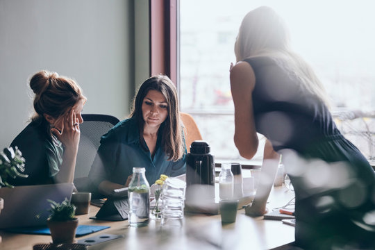 Confident female entrepreneurs planning strategy during meeting in board room at office