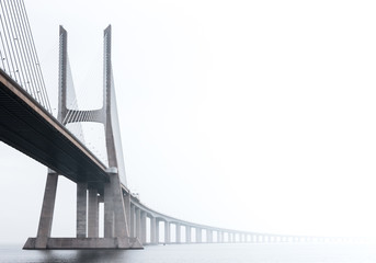 Ponte Vasco da Gama, Lisbon on a misty morning in March. Large concrete bridge across River Tagus,...