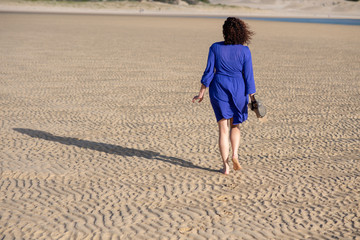 Woman walking on sand