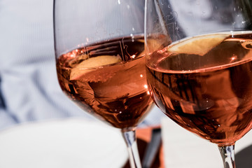Close up of two wine glasses of Aperol Spritz.