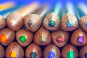 Sharpened colored pencils close-up. Ready-to-use pencils in a stack. Backlight in the back of the pile of pencils.
