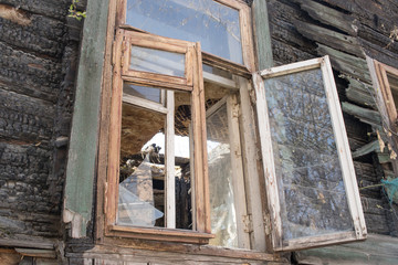 wooden frame with a broken window in an abandoned burnt house