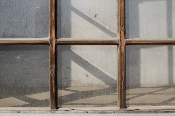 Old tall wooden window covered in dust