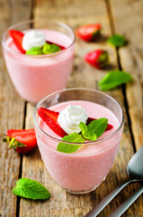 Strawberry panna cotta with mint leaves and fresh strawberries