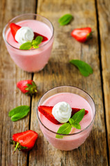Strawberry panna cotta with mint leaves and fresh strawberries