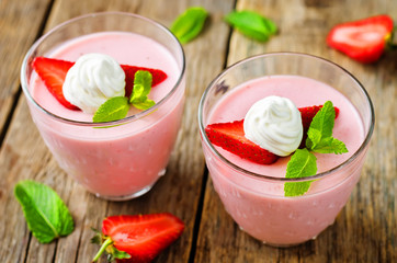 Strawberry panna cotta with mint leaves and fresh strawberries