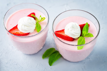 Strawberry panna cotta with mint leaves and fresh strawberries