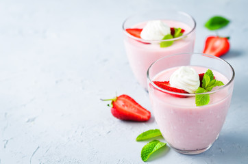 Strawberry panna cotta with mint leaves and fresh strawberries