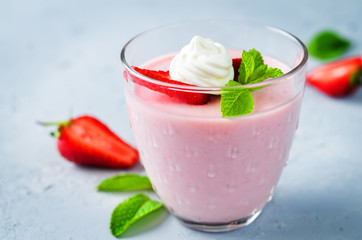 Strawberry panna cotta with mint leaves and fresh strawberries