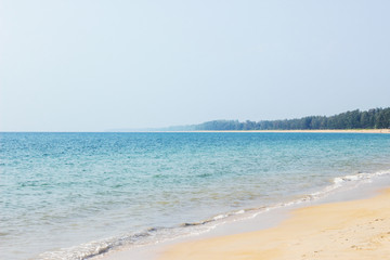 seascape at empty tropical beach with green island