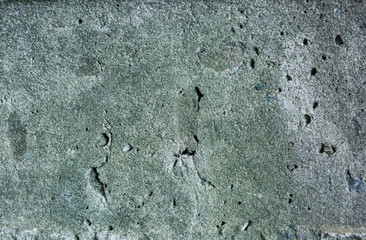 Grey and green abstract textured grunge wall background   for use in design. Wall fragment with cracks, scratches 